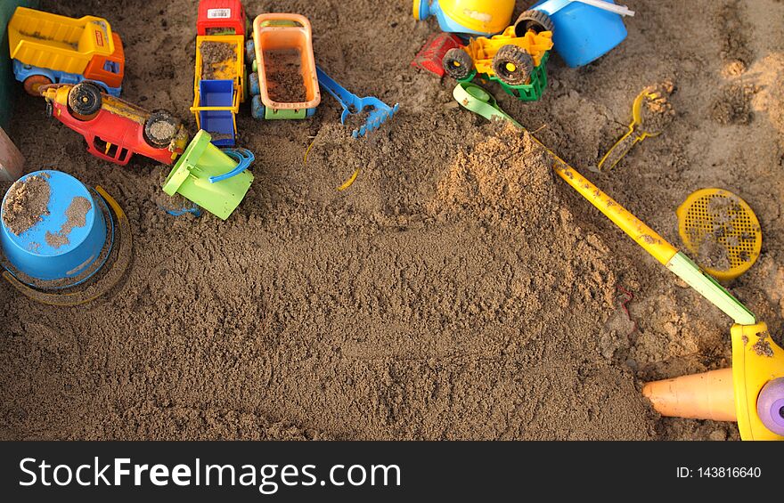 Top of view of a sandbox with toys on playground in sunny day