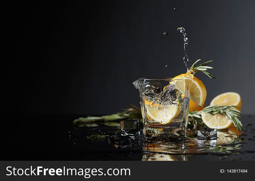 Cocktail Gin-tonic With Lemon Slices And Twigs Of Rosemary