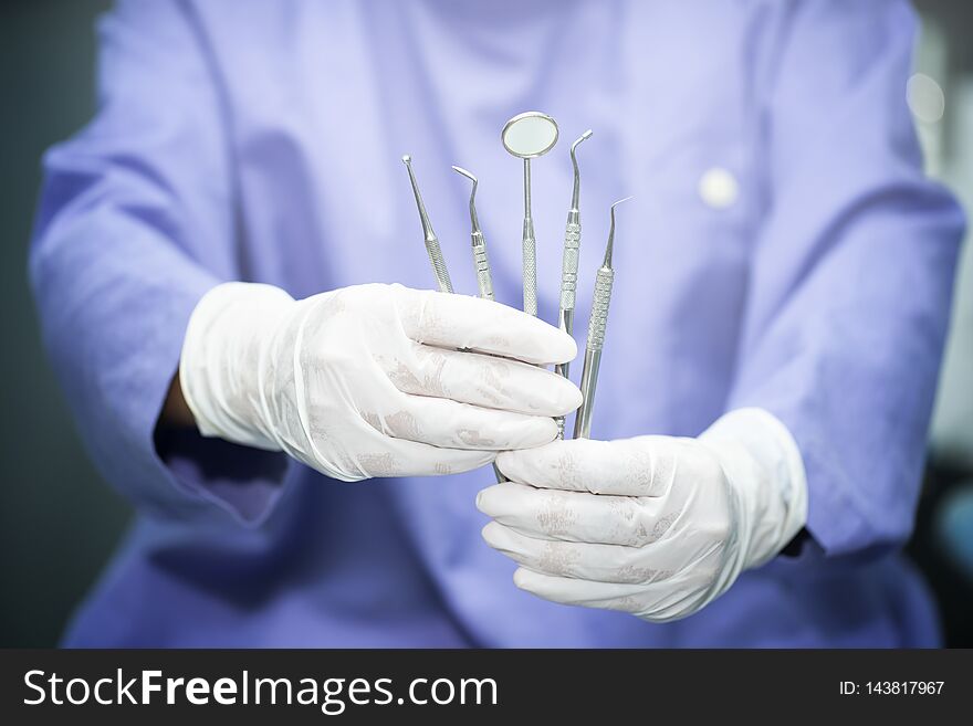 Close up Dentist holding dental equipment