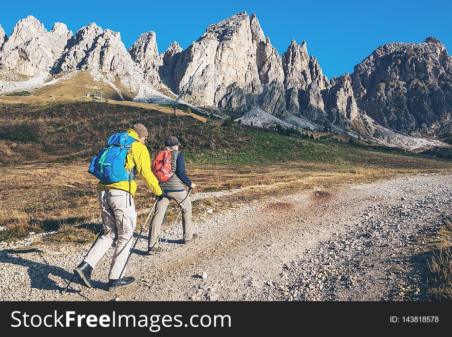 Travelers hiking in breathtaking landscape of Dolomites Mounatins in summer in Italy. Travel Lifestyle wanderlust adventure concept. Outdoor wilderness vacations. Travelers hiking in breathtaking landscape of Dolomites Mounatins in summer in Italy. Travel Lifestyle wanderlust adventure concept. Outdoor wilderness vacations