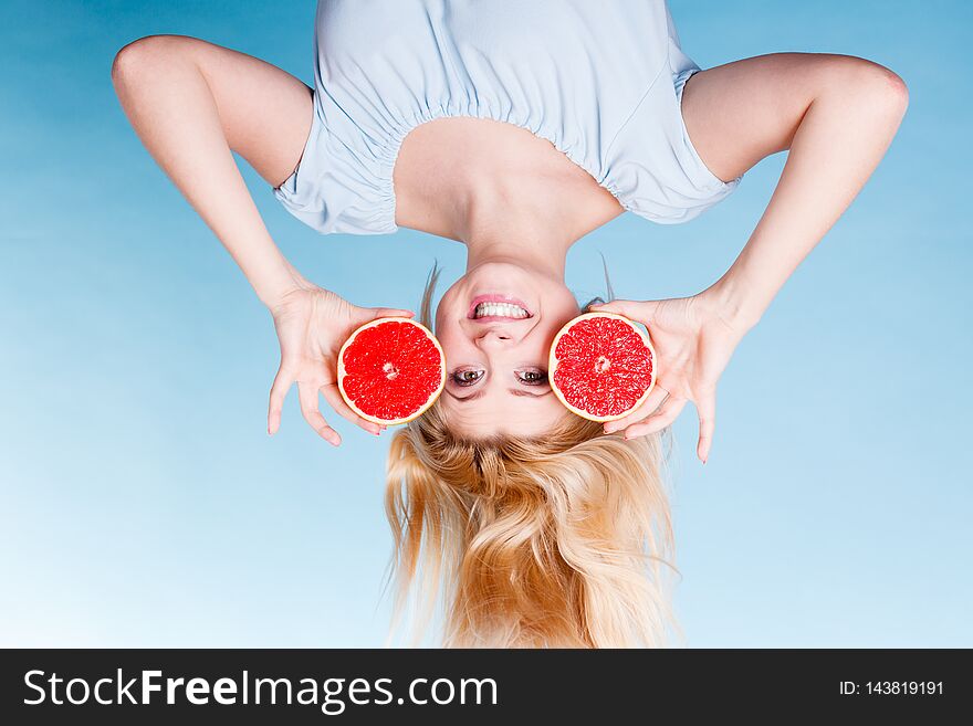 Healthy diet, refreshing food full of vitamins. Happy crazy woman holding sweet delicious citrus fruit, red grapefruit. Healthy diet, refreshing food full of vitamins. Happy crazy woman holding sweet delicious citrus fruit, red grapefruit