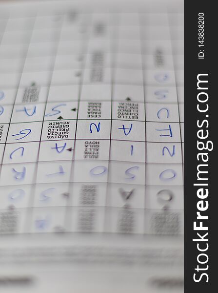 Crosswords puzzle`s notebook with letters and definitions in blue