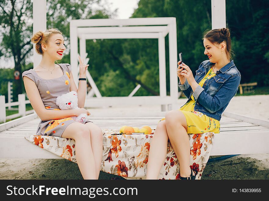 Two pretty girls in a summer park