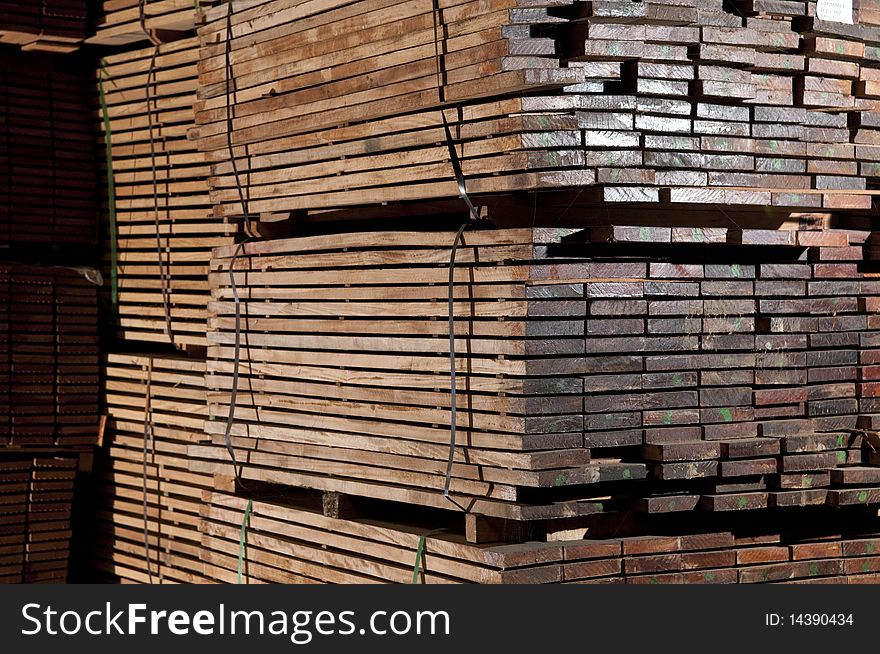 Tacks of a hardwood in lumber warehouse ready for transportation. Tacks of a hardwood in lumber warehouse ready for transportation.