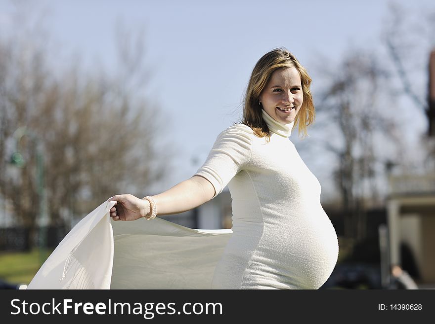 Happy young pregnant womant have fun outdoor in nature at sunny day. Happy young pregnant womant have fun outdoor in nature at sunny day