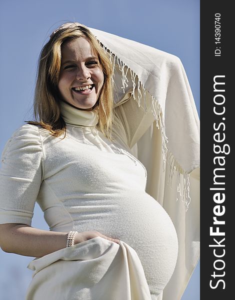Happy young pregnant woman outdoor