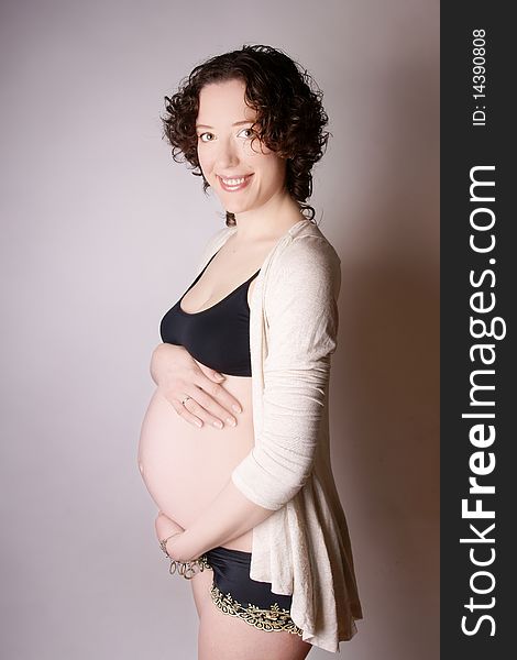 Young beautiful happy smiling pregnant woman, studio shot