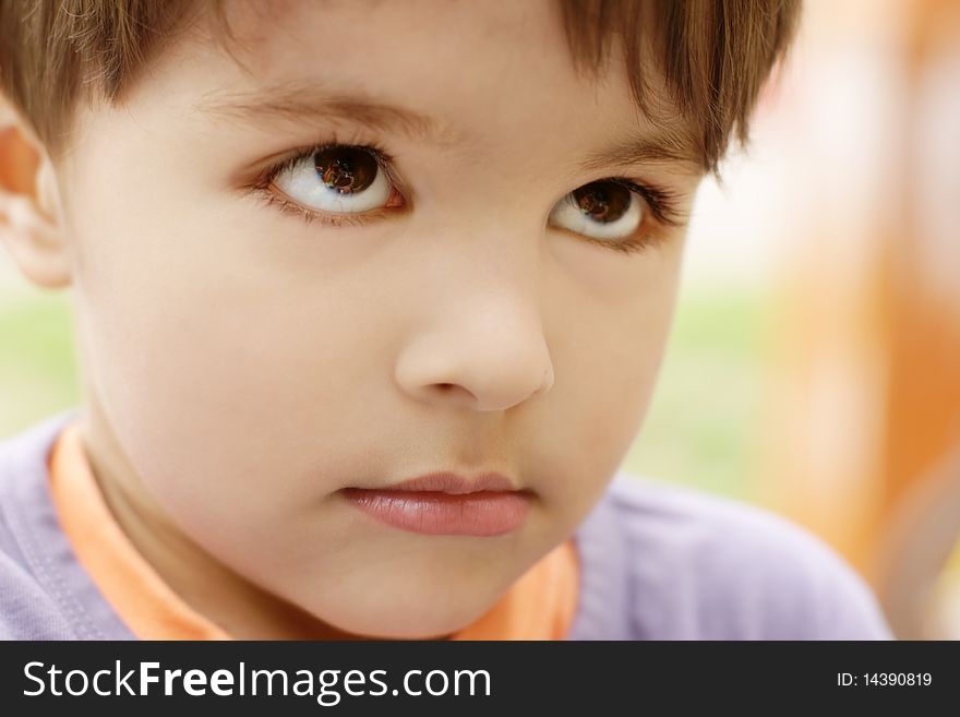 Portrait of cute little sad offended boy, outdoor shot. Portrait of cute little sad offended boy, outdoor shot