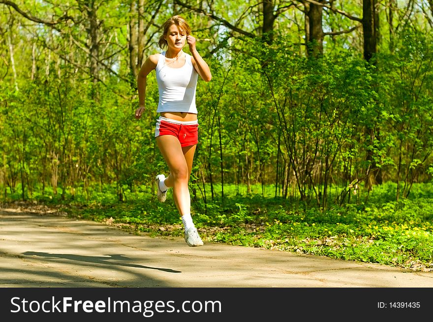 Young woman running in park. Young woman running in park