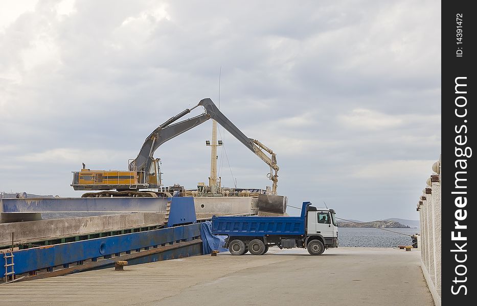 Crane Unloads A Ship In A Truck In The Port