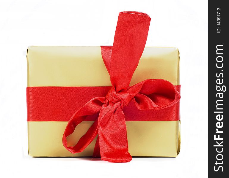 Gift packing of golden colour with red tape on white background