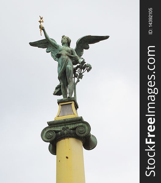 Angel statue on column at cechuv bridge, Prague