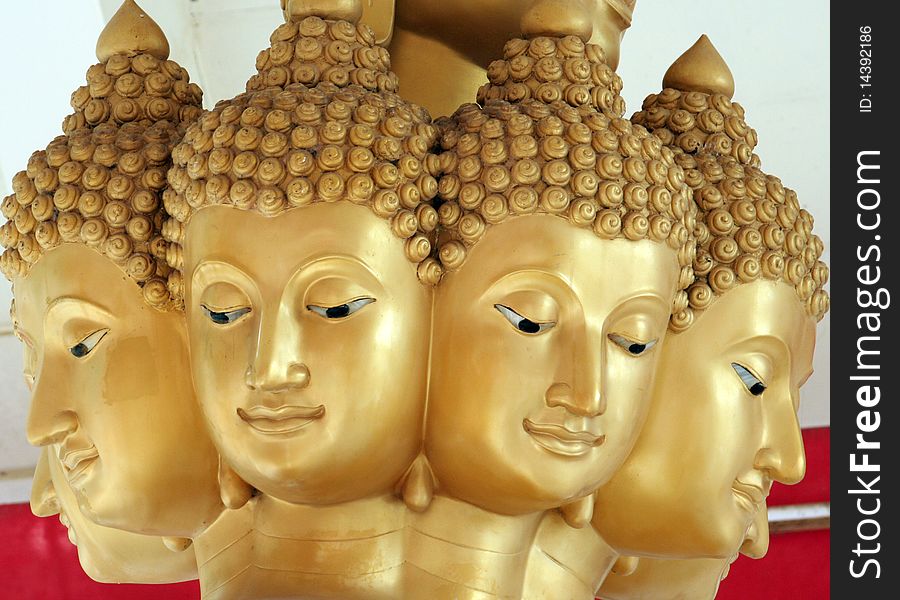 Multiple faces of gold buddha in the temple. Multiple faces of gold buddha in the temple