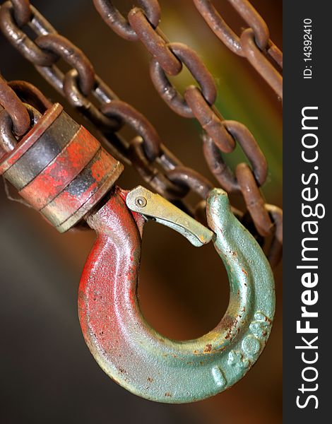 A photograph of rusty chains and a hook of near. A photograph of rusty chains and a hook of near