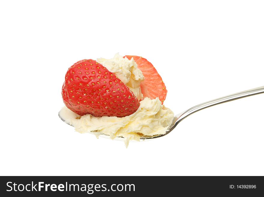 Strawberry and clotted cream in a spoon against white