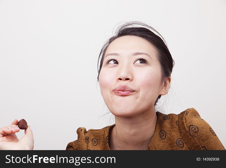 Attractive young lady enjoying chocolate