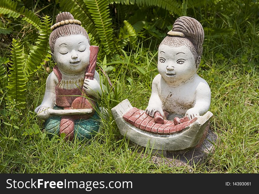 Asian figurines in the grass