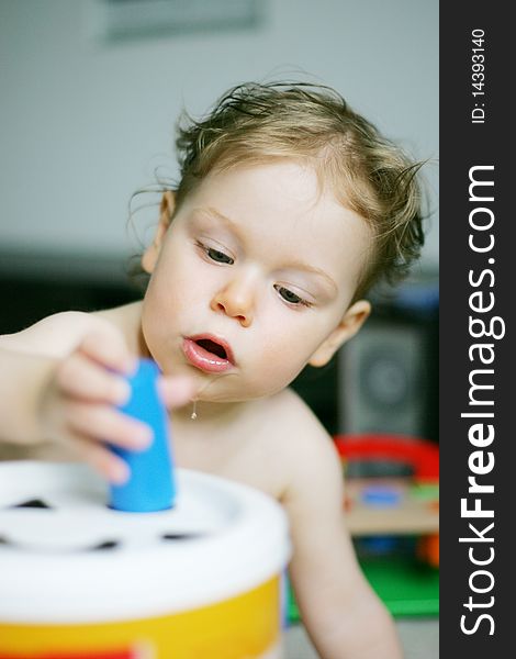 Teething baby concentraiting on play education toy. Teething baby concentraiting on play education toy