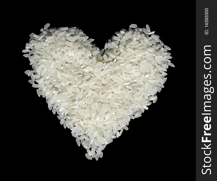 Rice grains in the form of heart on a black background
