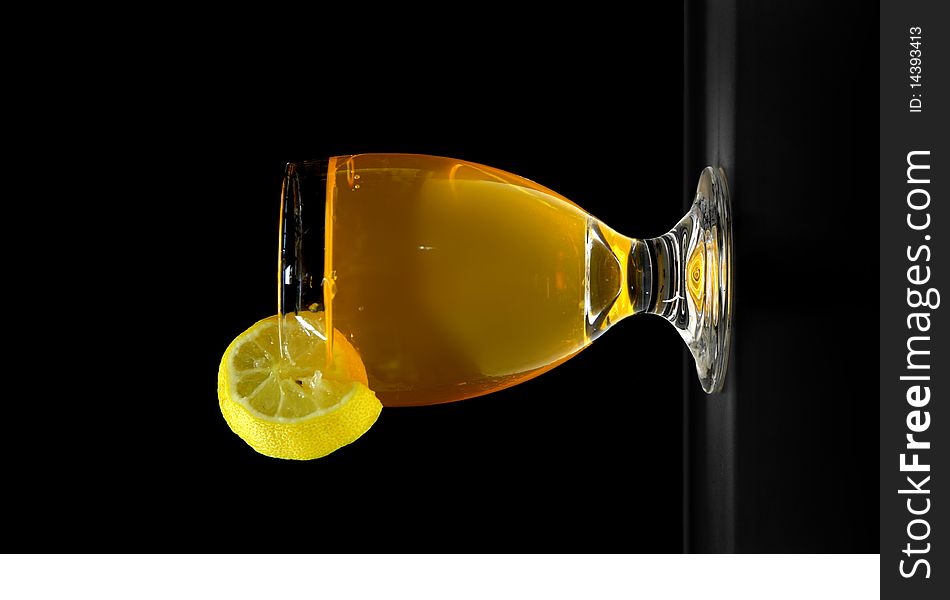 Orange juice glass with lemon on Black. Orange juice glass with lemon on Black