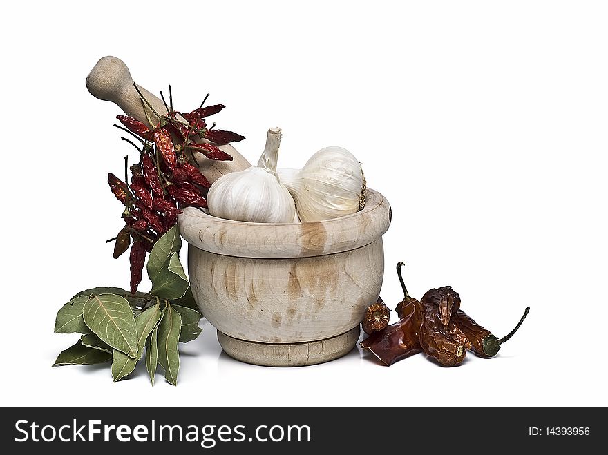 Some spices and a mortar grinder isolated on a white background. Some spices and a mortar grinder isolated on a white background.