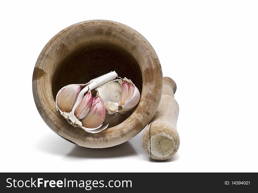 Garlic, mortar and pestle isolated on a white background. Garlic, mortar and pestle isolated on a white background.