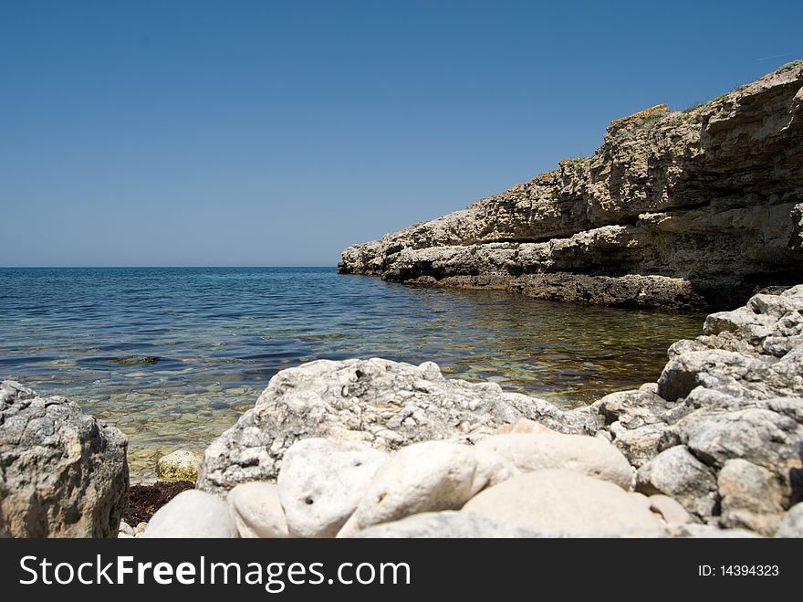 View on a quiet lagoon with rocky cliffs around the bay