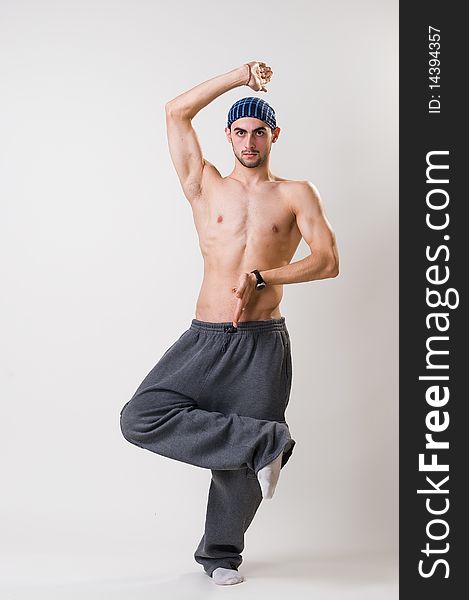 Handsome young dancer concentrated, studio shot