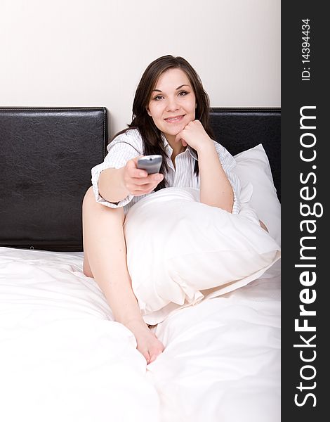 Young adult woman relaxing in bed. Young adult woman relaxing in bed