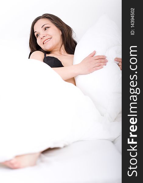Young adult woman relaxing in bed. Young adult woman relaxing in bed