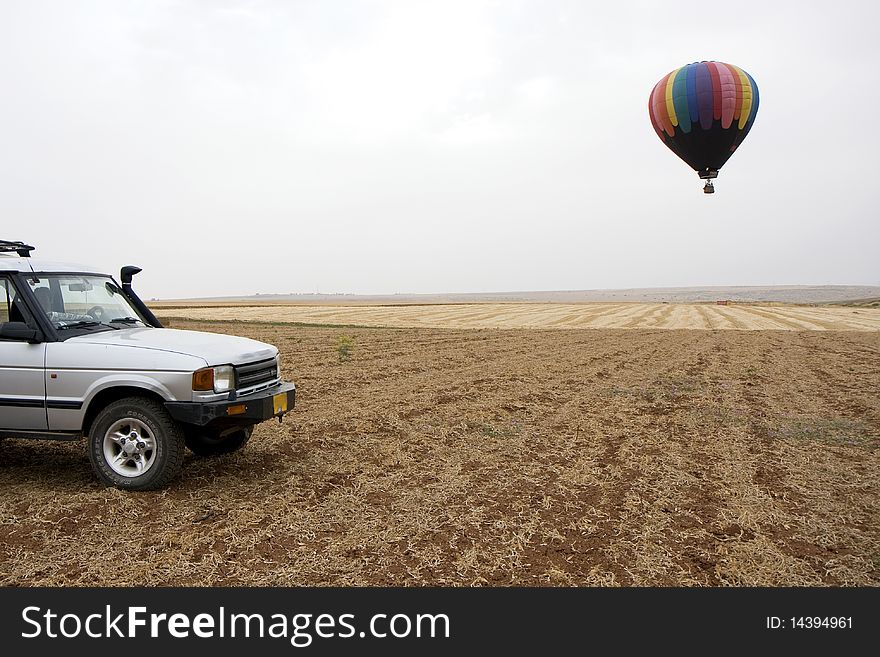 A hot air balloon above fields landscape