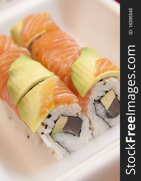 Two salmon rolls in a take-away styrofoam container. Two salmon rolls in a take-away styrofoam container.