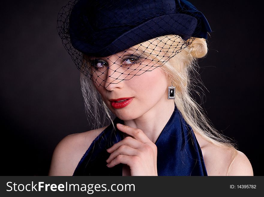 Portrait of a beautiful blonde woman wearing hat with veil. Portrait of a beautiful blonde woman wearing hat with veil