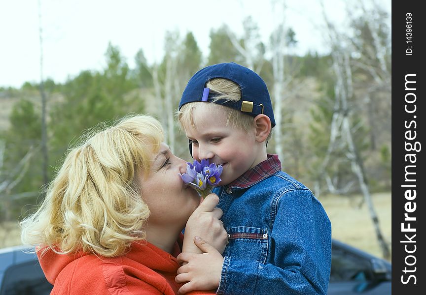 Mum, the son, a bouquet of snowdrops. A family photo.