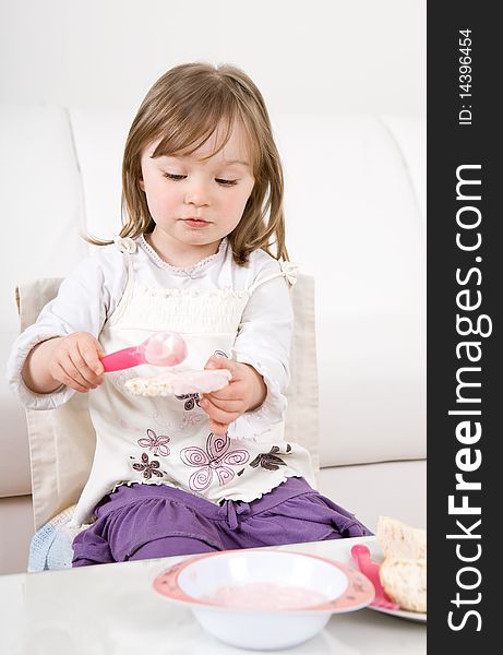 Sweet happy little girl eating