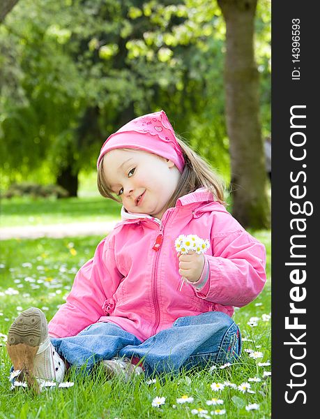 Sweet happy little girl in park