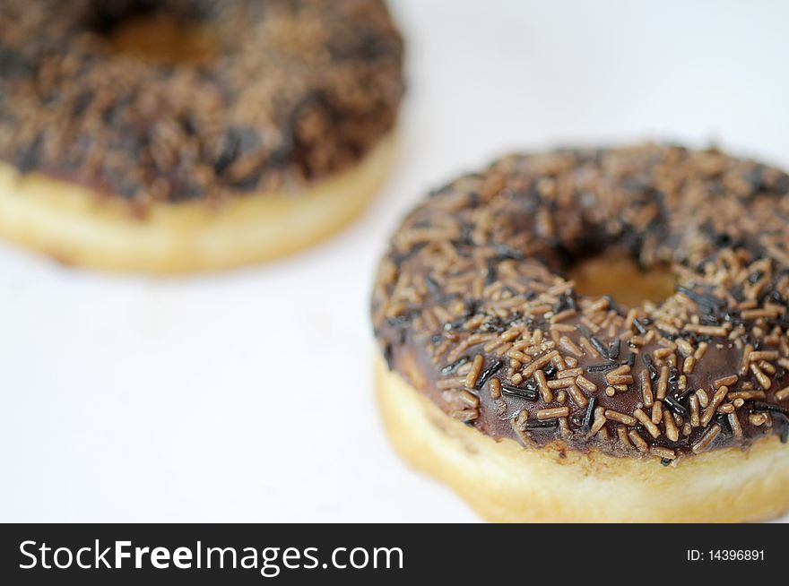 Two chocolate donut on a white background. Two chocolate donut on a white background.