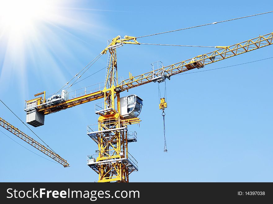 Industrial crane with blue sky background.