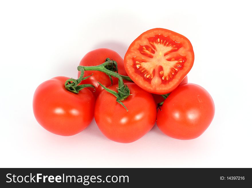 Red tomatoes on the branch isolated on white