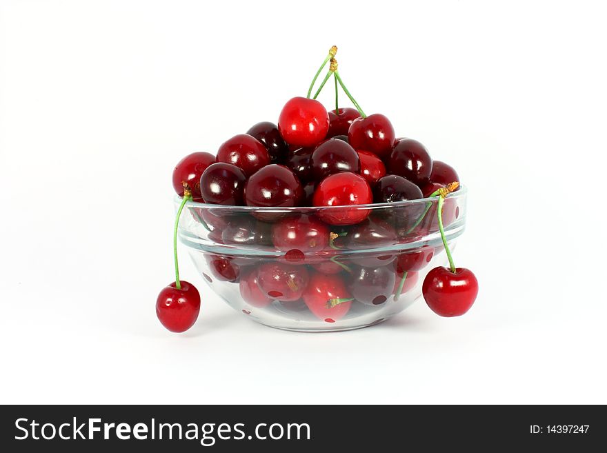 Sweet cherries in a glass bowl isolated on white