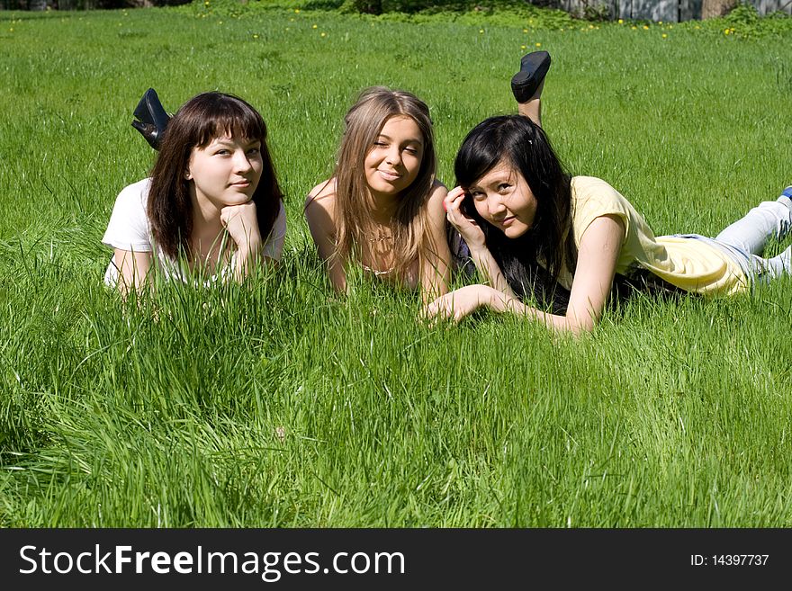 Three girls lying on grass