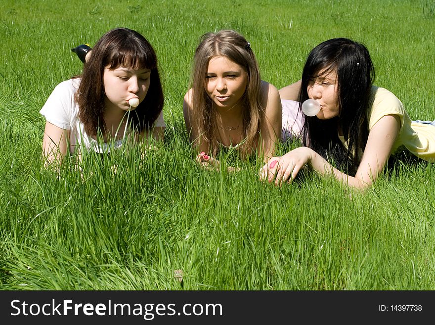 Three girls lying on grass