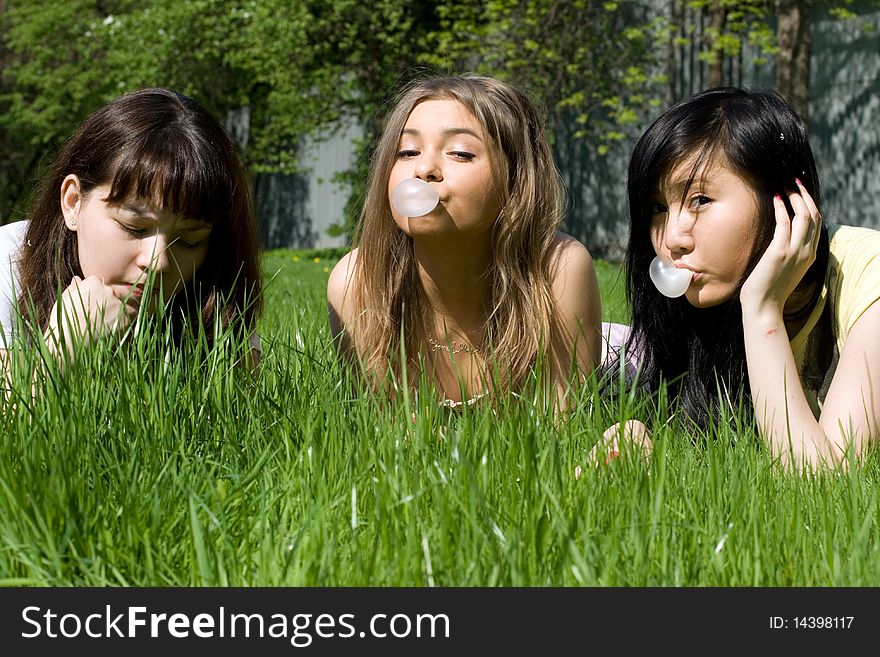 Three girls lying on grass