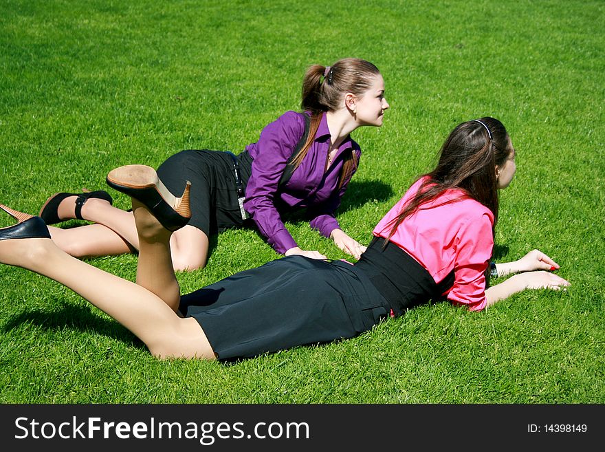 Young businesswomen relaxing on the grass