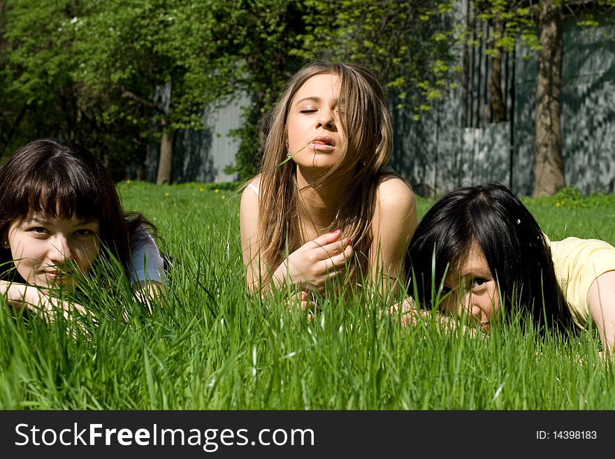 Three girls lying on grass