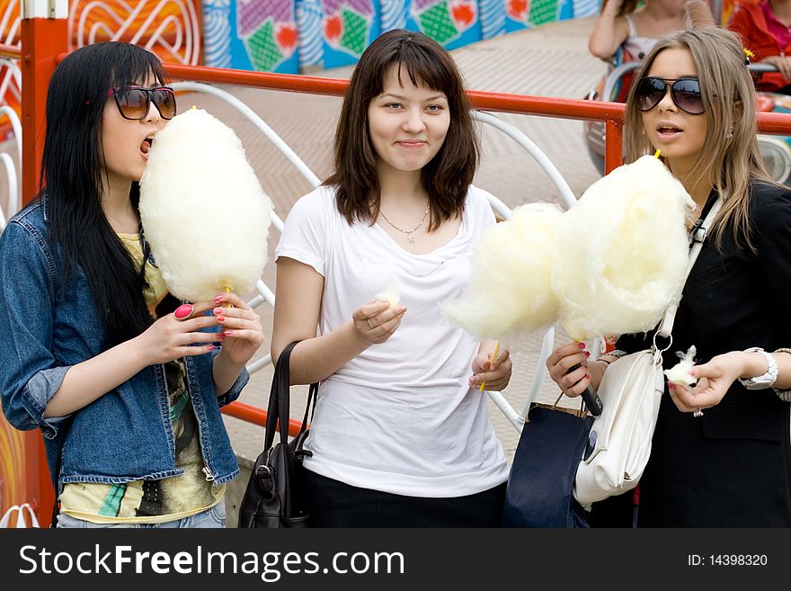 Three girls eating candy floss