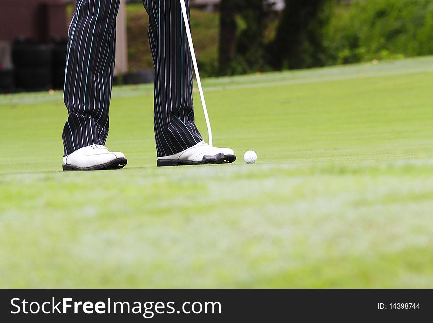 A golfer putting on the golf course