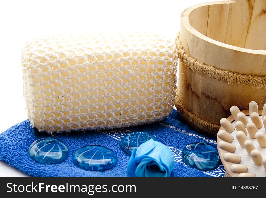 Massage sponge on blue towel and stones. Massage sponge on blue towel and stones