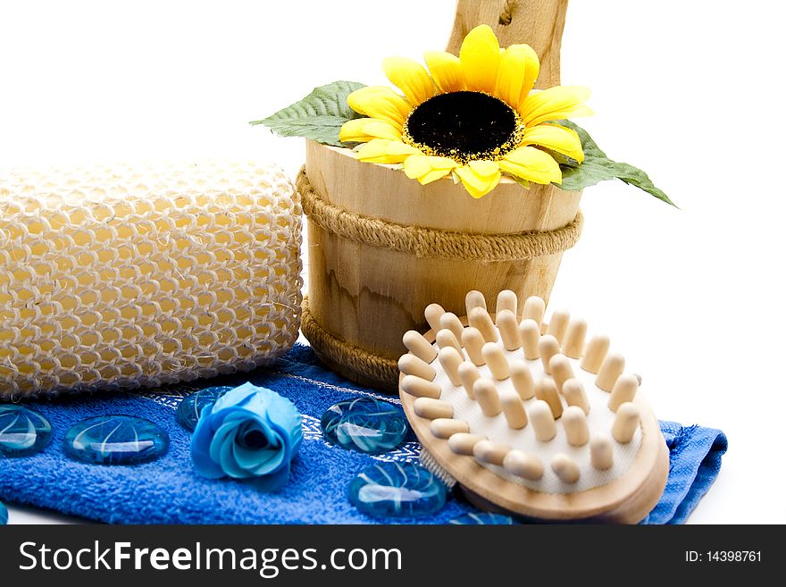 Massage sponge on blue towel and brush