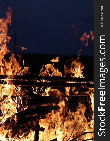 Uncontrolled fire against the dark background. Uncontrolled fire against the dark background